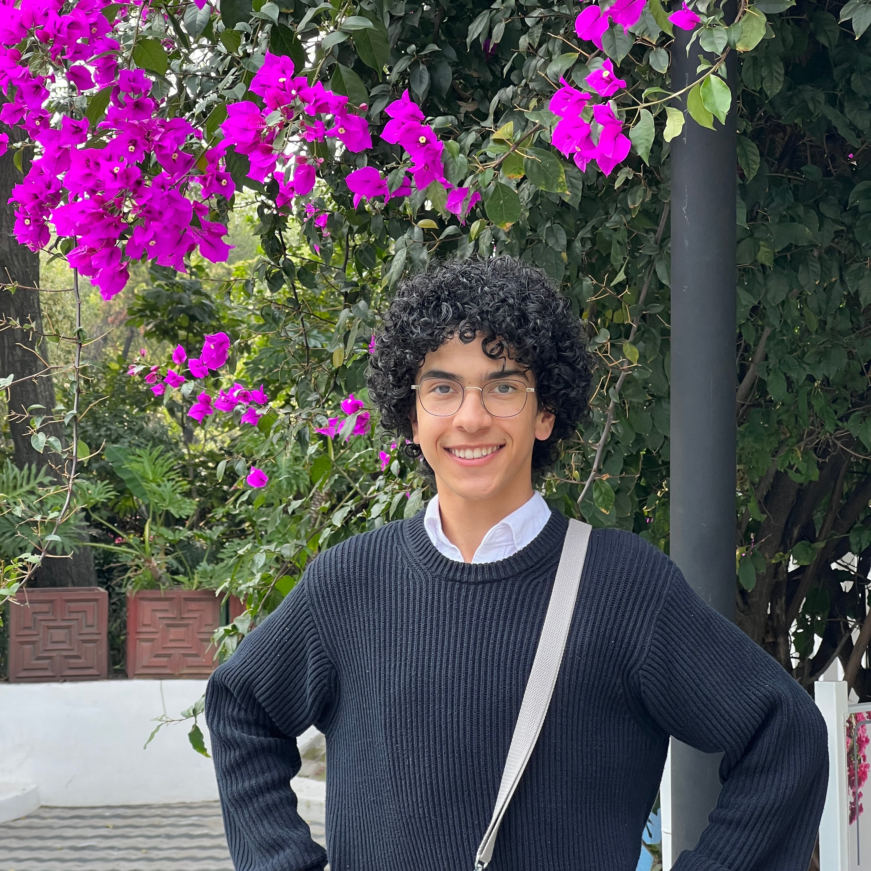 Jonathan standing in front of a Jacaranda tree.